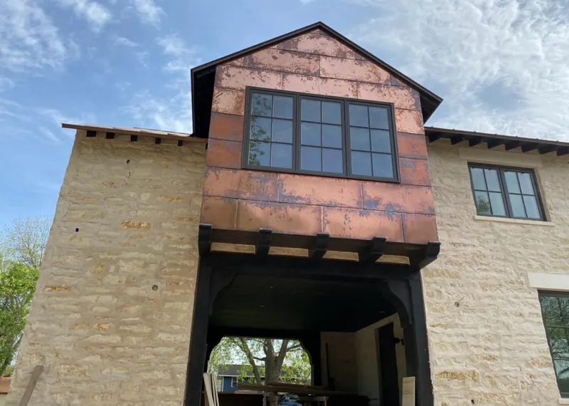 Copper metal panel facade on a stone building for Metal Roof Coating in Williams